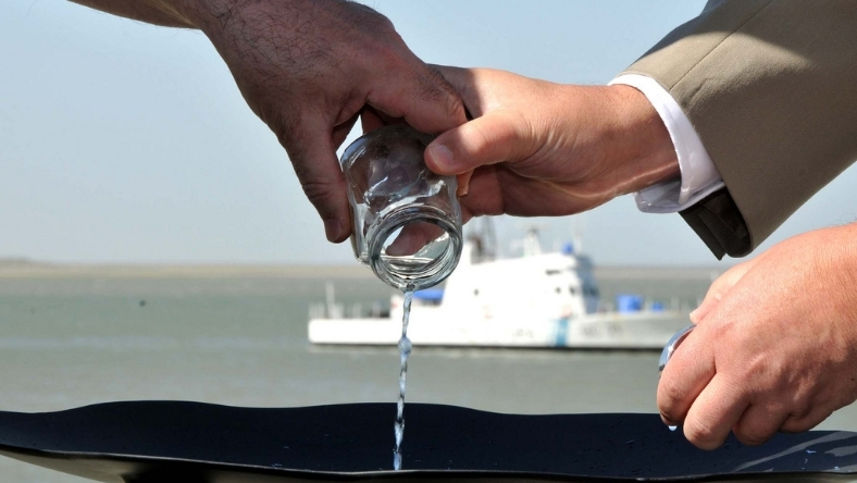 Water being poured from a glass to demonstrate chemical-free water treatment