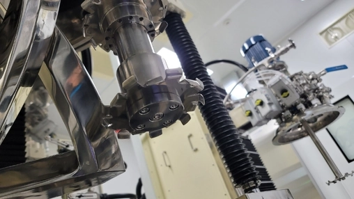 Industrial extraction equipment in a laboratory with a milling tool in focus and mechanical components behind